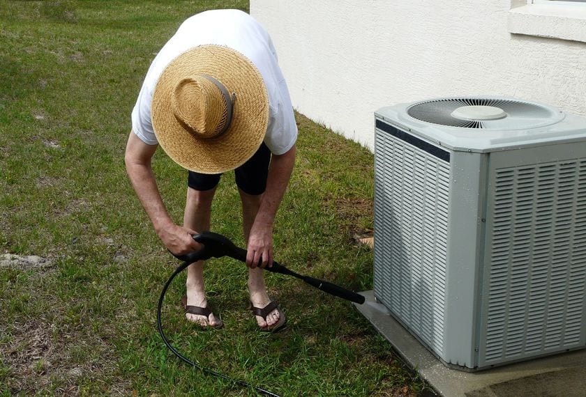 man power washing outdoor ac unit in evanston wy